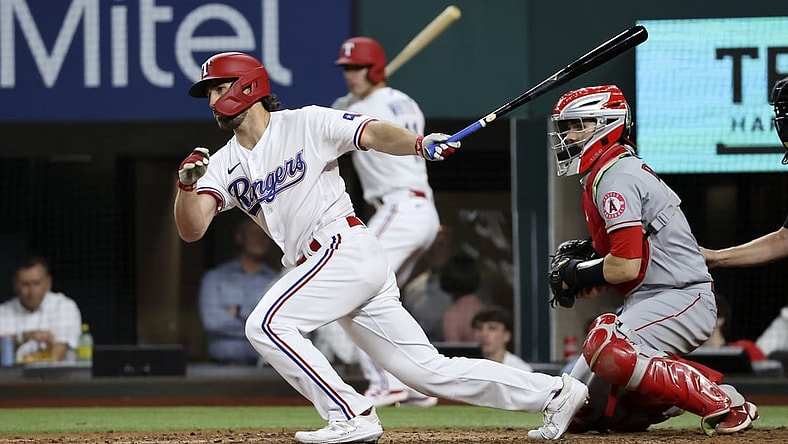 Apr 27, 2021; Arlington, Texas, USA;  Texas Rangers third baseman Charlie Culberson (2) hits an rbi single during the fourth inning against the Los Angeles Angels at Globe Life Field. Mandatory Credit: Kevin Jairaj-USA TODAY Sports