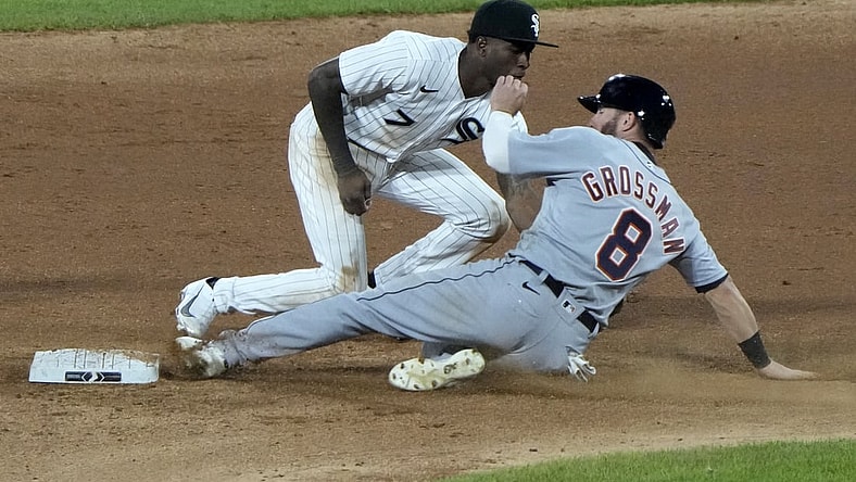 Apr 27, 2021; Chicago, Illinois, USA; Detroit Tigers left fielder Robbie Grossman (8) slides in safely into second base ahead of the tag by Chicago White Sox shortstop Tim Anderson (7) during the sixth inning at Guaranteed Rate Field. Mandatory Credit: Mike Dinovo-USA TODAY Sports
