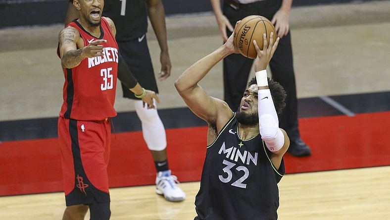 Apr 27, 2021; Houston, Texas, USA; Minnesota Timberwolves center Karl-Anthony Towns (32) shoots against Houston Rockets center Christian Wood (35) in the first quarter at Toyota Center. Mandatory Credit: Thomas Shea-USA TODAY Sports