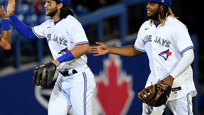 Apr 27, 2021; Dunedin, Florida, CAN; Toronto Blue Jays infielder Vladimir Guerrero Jr. (R) and infielder Bo Bichette (L) celebrate after defeating the Washington Nationals at TD Ballpark. Mandatory Credit: Jonathan Dyer-USA TODAY Sports