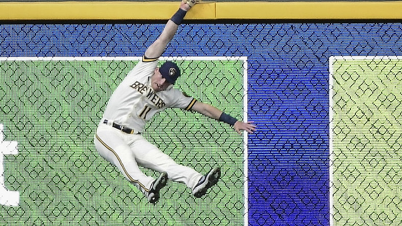 Apr 28, 2021; Milwaukee, Wisconsin, USA;  Milwaukee Brewers left fielder Billy McKinney (11) misses catching a ball hit by Miami Marlins first baseman Jesus Aguilar (not pictured) for a 3 run home run in the fourth inning at American Family Field. Mandatory Credit: Benny Sieu-USA TODAY Sports
