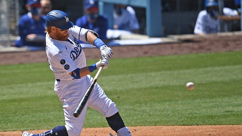 Apr 28, 2021; Los Angeles, California, USA;  Los Angeles Dodgers third baseman Justin Turner (10) as he hits a solo home run in the third inning of the game against the Cincinnati Reds at Dodger Stadium. Mandatory Credit: Jayne Kamin-Oncea-USA TODAY Sports