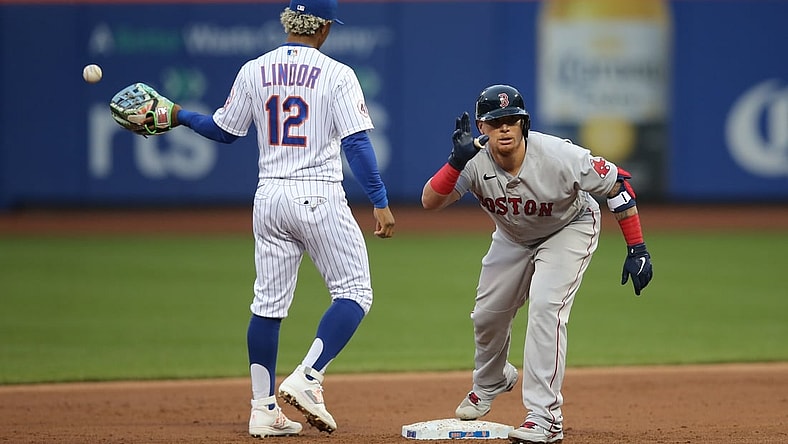 Apr 28, 2021; New York City, New York, USA; Boston Red Sox catcher  Christian Vazquez (7) reacts after his RBI double as New York Mets shortstop Francisco Lindor (12) takes the throw from the outfield during the second inning at Citi Field. Mandatory Credit: Brad Penner-USA TODAY Sports