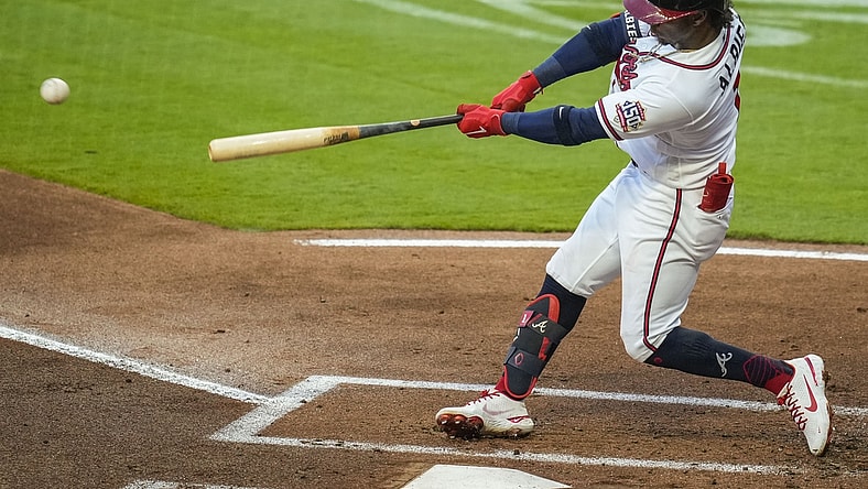 Apr 28, 2021; Cumberland, Georgia, USA; Atlanta Braves second baseman Ozzie Albies (1) hits a double against the Chicago Cubs during the first inning at Truist Park. Mandatory Credit: Dale Zanine-USA TODAY Sports