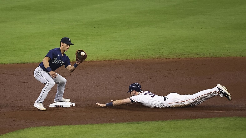 Apr 28, 2021; Houston, Texas, USA; Houston Astros right fielder Kyle Tucker (30) slides safely into second base as Seattle Mariners second baseman Sam Haggerty (0) fields a throw during the second inning at Minute Maid Park. Mandatory Credit: Troy Taormina-USA TODAY Sports