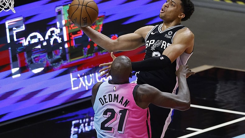 Apr 28, 2021; Miami, Florida, USA;  San Antonio Spurs forward Keldon Johnson (3) shoots around Miami Heat center Dewayne Dedmon (21) during the first half at American Airlines Arena. Mandatory Credit: Rhona Wise-USA TODAY Sports