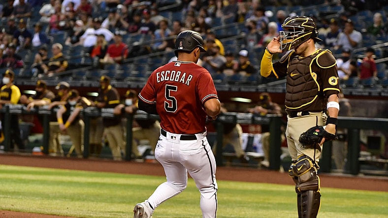 Apr 28, 2021; Phoenix, Arizona, USA;  Arizona Diamondbacks third baseman Eduardo Escobar (5) scores in the second inning against the San Diego Padres at Chase Field. Mandatory Credit: Matt Kartozian-USA TODAY Sports