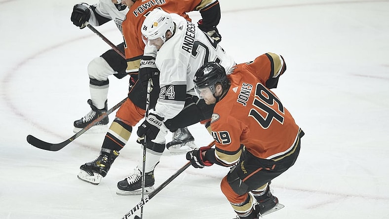 Apr 28, 2021; Los Angeles, California, USA; Los Angeles Kings center Lias Andersson (24) moves the puck while defended by Anaheim Ducks left wing Max Jones (49) during the first period at Staples Center. Mandatory Credit: Kelvin Kuo-USA TODAY Sports