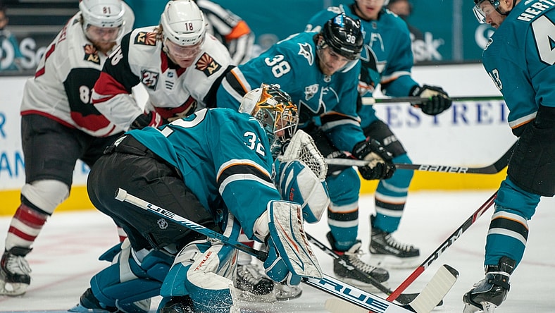 Apr 28, 2021; San Jose, California, USA;  San Jose Sharks goaltender Josef Korenar (32) makes a save against Arizona Coyotes center Christian Dvorak (18) during the first period at SAP Center at San Jose. Mandatory Credit: Neville E. Guard-USA TODAY Sports