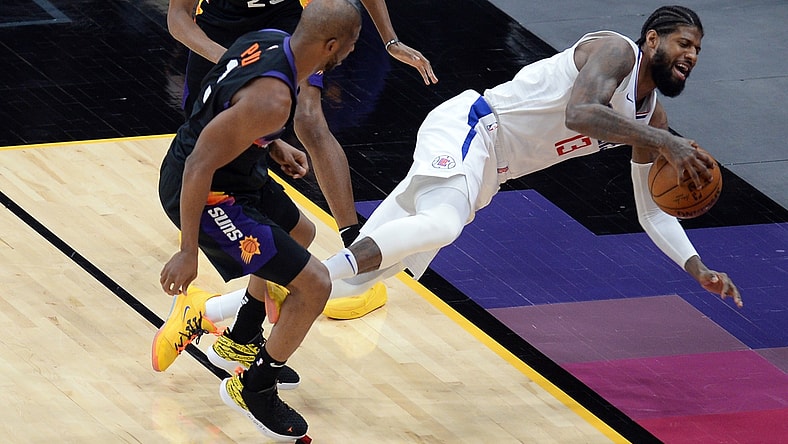 Apr 28, 2021; Phoenix, Arizona, USA; Phoenix Suns guard Chris Paul (3) fouls LA Clippers guard Paul George (13) during the second half at Phoenix Suns Arena. Mandatory Credit: Joe Camporeale-USA TODAY Sports