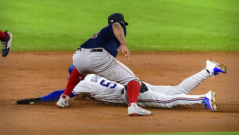 Apr 29, 2021; Arlington, Texas, USA; Boston Red Sox third baseman Rafael Devers (11) tags out Texas Rangers right fielder Adolis Garcia (53) during the second inning at Globe Life Field. Mandatory Credit: Jerome Miron-USA TODAY Sports