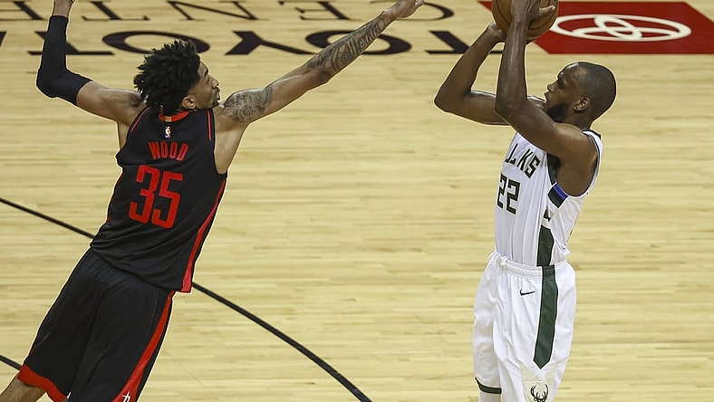 Apr 29, 2021; Houston, Texas, USA; Milwaukee Bucks forward Khris Middleton (22) shoots the ball as Houston Rockets center Christian Wood (35) defends during the third quarter at Toyota Center. Mandatory Credit: Troy Taormina-USA TODAY Sports