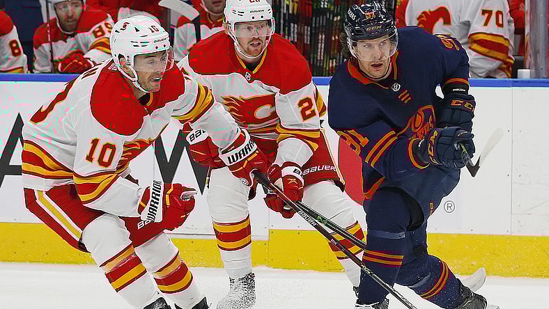 Apr 29, 2021; Edmonton, Alberta, CAN; Calgary Flames forward Derek Ryan (10) and Edmonton Oilers forward Gaetan Haas (91) look for a loose puck during the first period at Rogers Place. Mandatory Credit: Perry Nelson-USA TODAY Sports