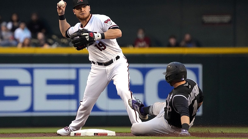 Apr 29, 2021; Phoenix, Arizona, USA; Arizona Diamondbacks second baseman Josh VanMeter (19) turns the double play while avoiding Colorado Rockies second baseman Garrett Hampson (1) in the first inning at Chase Field. Mandatory Credit: Rick Scuteri-USA TODAY Sports