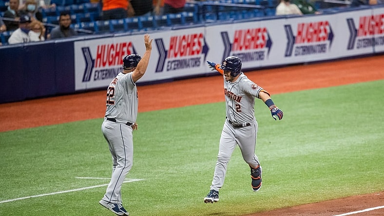 Apr 30, 2021; St. Petersburg, Florida, USA; Houston Astros third baseman Alex Bregman (2) celebrates with third base coach Omar Lopez (22) after hitting a home run during the third inning of a game against the Tampa Bay Rays at Tropicana Field. Mandatory Credit: Mary Holt-USA TODAY Sports
