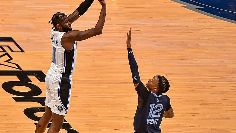 Apr 30, 2021; Memphis, Tennessee, USA; Orlando Magic forward James Ennis III (11) shoots against Memphis Grizzlies guard Ja Morant (12) during the first half at FedExForum. Mandatory Credit: Justin Ford-USA TODAY Sports