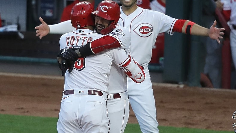Apr 30, 2021; Cincinnati, Ohio, USA; Cincinnati Reds first baseman Joey Votto (19) reacts with right fielder Nick Castellanos (middle) and shortstop Eugenio Suarez (right) after hitting a two-run home run, the 300th of his major league career during the third inning against the Chicago Cubs at Great American Ball Park. Mandatory Credit: David Kohl-USA TODAY Sports