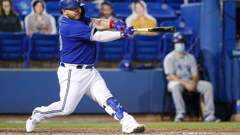 Apr 30, 2021; Dunedin, Florida, CAN;  Toronto Blue Jays catcher Alejandro Kirk (30) hits a two-run home run in the fourth inning against the Atlanta Braves at TD Ballpark. Mandatory Credit: Nathan Ray Seebeck-USA TODAY Sports