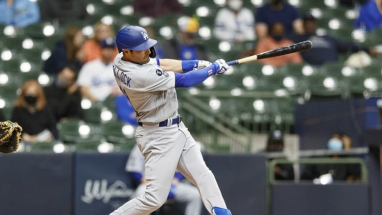 Apr 30, 2021; Milwaukee, Wisconsin, USA;  Los Angeles Dodgers left fielder AJ Pollock (11) hits a solo home run during the fifth inning against the Milwaukee Brewers at American Family Field. Mandatory Credit: Jeff Hanisch-USA TODAY Sports