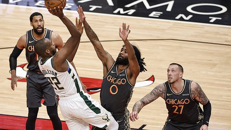 Apr 30, 2021; Chicago, Illinois, USA; Milwaukee Bucks forward Khris Middleton (22) shoots against Chicago Bulls guard Coby White (0) during the first half of an NBA basketball game at United Center. Mandatory Credit: Kamil Krzaczynski-USA TODAY Sports