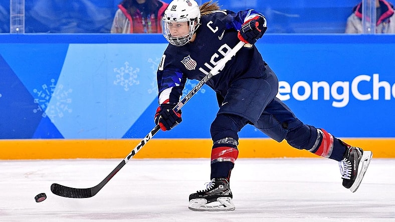Feb 18, 2018; Gangneung, South Korea; United States forward Meghan Duggan (10) shoots the puck against Finland in the women's ice hockey semifinals during the Pyeongchang 2018 Olympic Winter Games at Gangneung Hockey Centre. Mandatory Credit: Andrew Nelles-USA TODAY Sports
