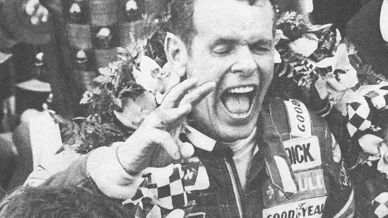Bobby Unser shouts for joy in Victory Lane with the wreath of orchids around his shoulders and the Borg-Warner trophy behind him on May 24, 1981.

Unser