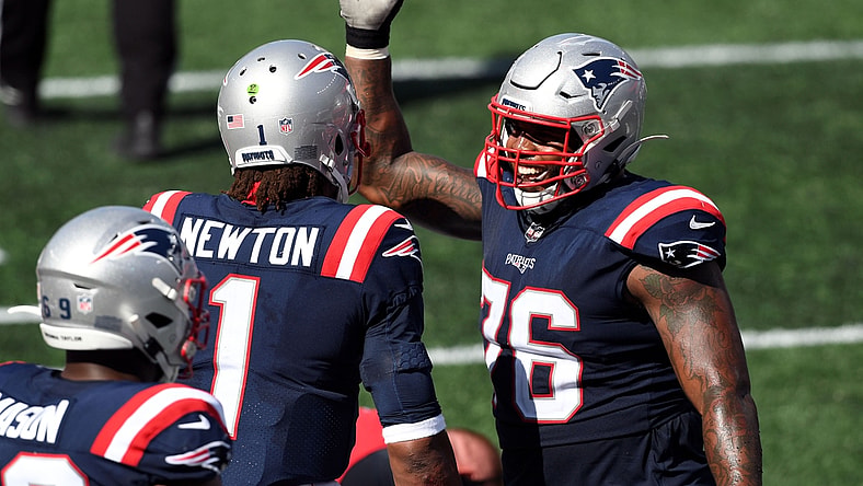 Sep 13, 2020; Foxborough, Massachusetts, USA; New England Patriots quarterback Cam Newton (1) celebrates with offensive tackle Isaiah Wynn (76) after scoring a touchdown against the Miami Dolphins during the third quarter at Gillette Stadium. Mandatory Credit: Brian Fluharty-USA TODAY Sports