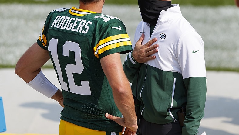 Sep 20, 2020; Green Bay, Wisconsin, USA; Green Bay Packers quarterback Aaron Rodgers (12) talks with head coach Matt LaFleur during the third quarter of the game against the Detroit Lions at Lambeau Field. Mandatory Credit: Jeff Hanisch-USA TODAY Sports