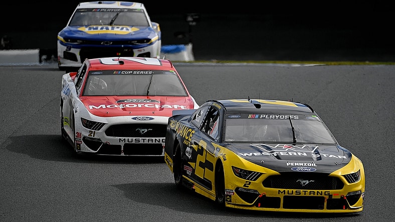 Oct 11, 2020; Concord, North Carolina, USA; NASCAR Cup Series driver Brad Keselowski (2) races ahead of Matt DiBenedetto (21) and Chase Elliott (9)during the Bank of America ROVAL 400 at Charlotte Motor Speedway. Mandatory Credit: Jasen Vinlove-USA TODAY Sports
