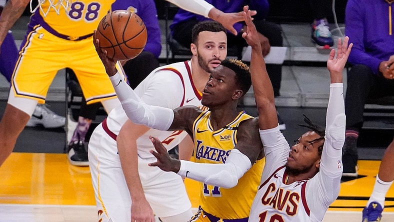 Mar 26, 2021; Los Angeles, California, USA; Los Angeles Lakers guard Dennis Schroder (17) drives to the hoop past Cleveland Cavaliers guard Darius Garland (10) during the first quarter at Staples Center. Mandatory Credit: Robert Hanashiro-USA TODAY Sports