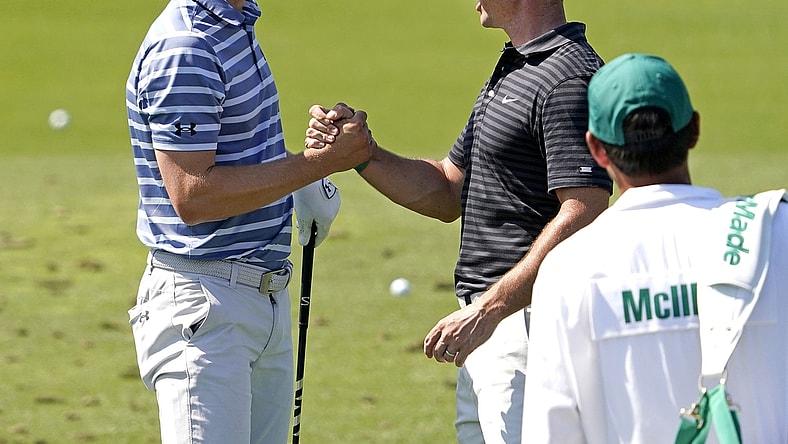 Apr 5, 2021; Augusta, Georgia, USA; Rory McIlroy congratulates Jordan Spieth (left) after winning the Valero Texas Open yesterday as they prepare for The Masters golf tournament at Augusta National Golf Club. Mandatory Credit: Rob Schumacher-USA TODAY Sports