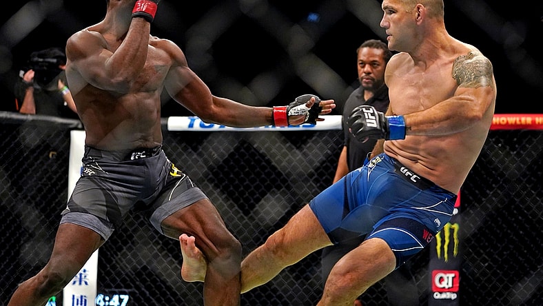 Apr 24, 2021; Jacksonville, Florida, USA; Chris Weidman (Blue Gloves) breaks his leg on his first kick against Uriah Hall (Red Gloves) during UFC 261 at VyStar Veterans Memorial Arena. Mandatory Credit: Jasen Vinlove-USA TODAY Sports
