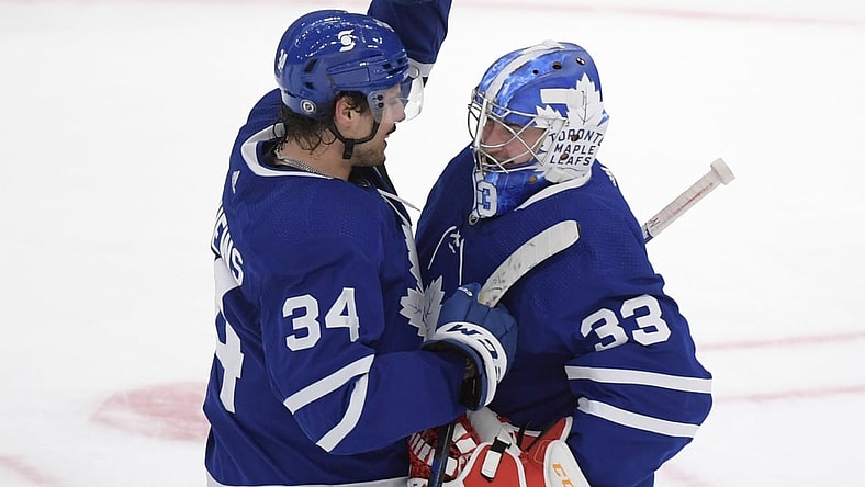 Apr 29, 2021; Toronto, Ontario, CAN;  Toronto Maple Leafs forward Auston Matthews (34) greets goalie David Rittich (33) as they celebrate a win over Vancouver Canucks at Scotiabank Arena. Mandatory Credit: Dan Hamilton-USA TODAY Sports