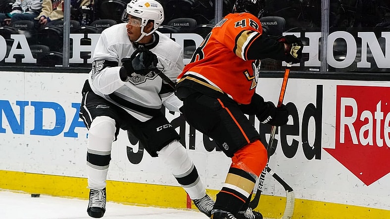 Apr 30, 2021; Anaheim, California, USA; Los Angeles Kings center Quinton Byfield (55) plays for the puck against Anaheim Ducks center Isac Lundestrom (48) during the first period at Honda Center. Mandatory Credit: Gary A. Vasquez-USA TODAY Sports