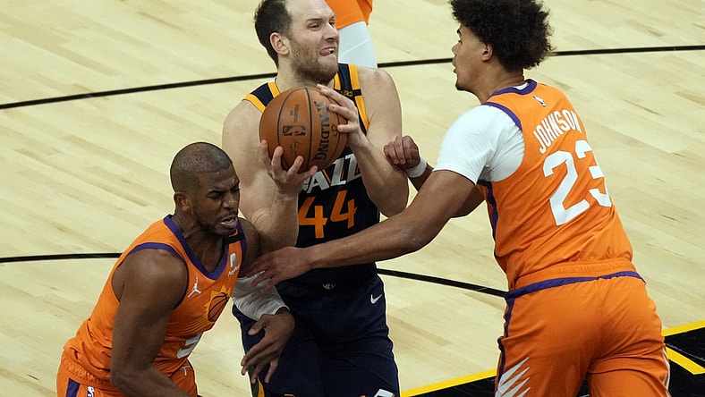 Apr 30, 2021; Phoenix, Arizona, USA; Utah Jazz forward Bojan Bogdanovic (44) drives between Phoenix Suns guard Chris Paul (3) and forward Cameron Johnson (23) in the first half at Phoenix Suns Arena. Mandatory Credit: Rick Scuteri-USA TODAY Sports