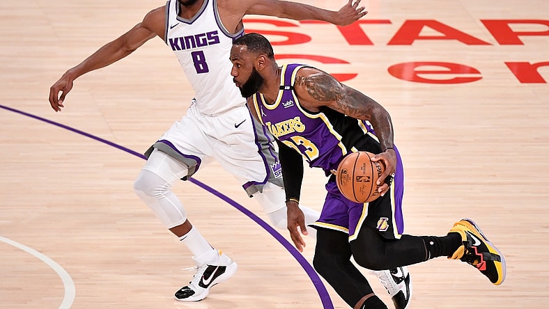 Apr 30, 2021; Los Angeles, California, USA; Los Angeles Lakers forward LeBron James (23) dribbles past Sacramento Kings forward Maurice Harkless (8) during the first quarter at Staples Center. James returned to the Lakers lineup after recovering from an ankle injury. Mandatory Credit: Robert Hanashiro-USA TODAY Sports