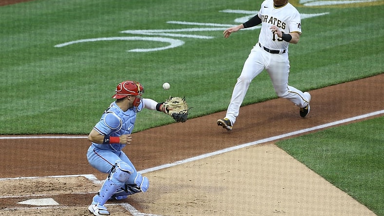 May 1, 2021; Pittsburgh, Pennsylvania, USA;  St. Louis Cardinals catcher Andrew Knizner (7) can not handle a throw from left fielder Tyler O'Neill (not pictured) allowing Pittsburgh Pirates first baseman Colin Moran (19) to score a run during the second inning at PNC Park. Mandatory Credit: Charles LeClaire-USA TODAY Sports