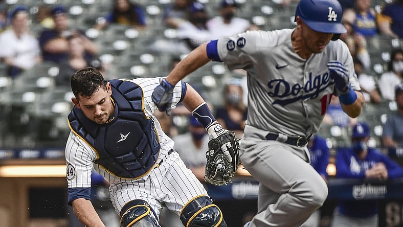 May 1, 2021; Milwaukee, Wisconsin, USA; Milwaukee Brewers catcher Luke Maile (12) throws out Los Angeles Dodgers catcher Austin Barnes (15) in the third inning at American Family Field. Mandatory Credit: Benny Sieu-USA TODAY Sports