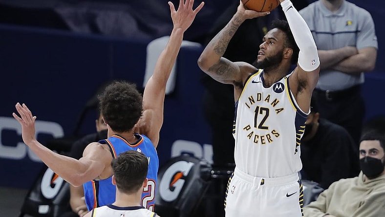 May 1, 2021; Oklahoma City, Oklahoma, USA; Indiana Pacers forward Oshae Brissett (12) shoots a three-point basket as Oklahoma City Thunder center Isaiah Roby (22) defends during the second quarter at Chesapeake Energy Arena. Mandatory Credit: Alonzo Adams-USA TODAY Sports