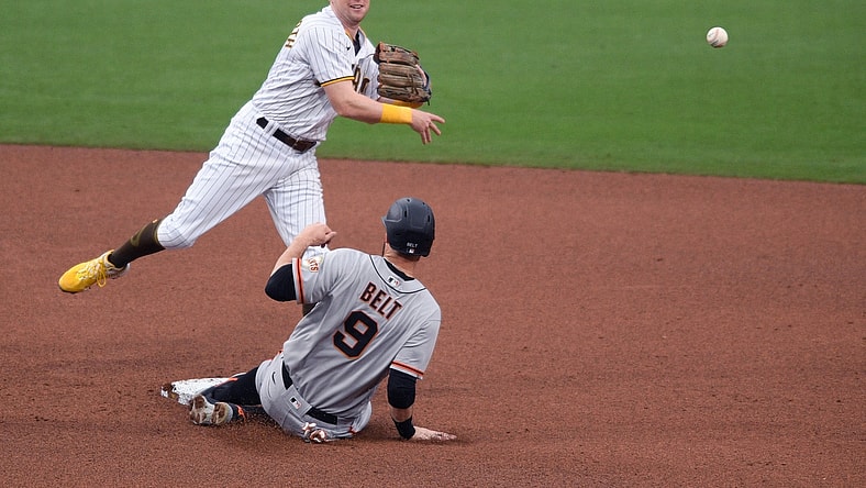 May 1, 2021; San Diego, California, USA; San Diego Padres second baseman Jake Cronenworth (L) forces out San Francisco Giants first baseman Brandon Belt (9) at second base before throwing to first base to compete the double play during the fourth inning at Petco Park. Mandatory Credit: Orlando Ramirez-USA TODAY Sports