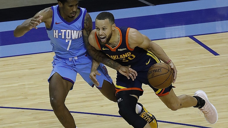 May 1, 2021; Houston, Texas, USA; Golden State Warriors guard Stephen Curry (30) drives against Houston Rockets guard Armoni Brooks (7) during the second quarter at Toyota Center. Mandatory Credit:  Bob Levey /POOL PHOTOS-USA TODAY Sports