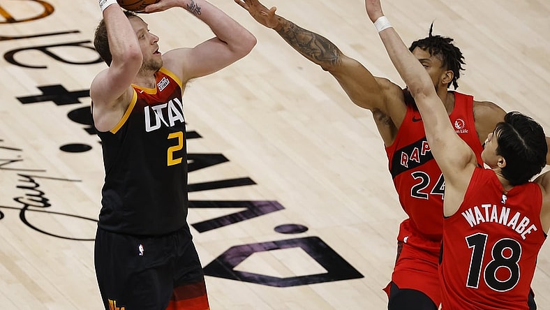 May 1, 2021; Salt Lake City, Utah, USA; Utah Jazz guard Joe Ingles (2) shoots for three points against Toronto Raptors center Khem Birch (24) and forward Yuta Watanabe (18) in the second quarter at Vivint Arena. Mandatory Credit: Jeffrey Swinger-USA TODAY Sports
