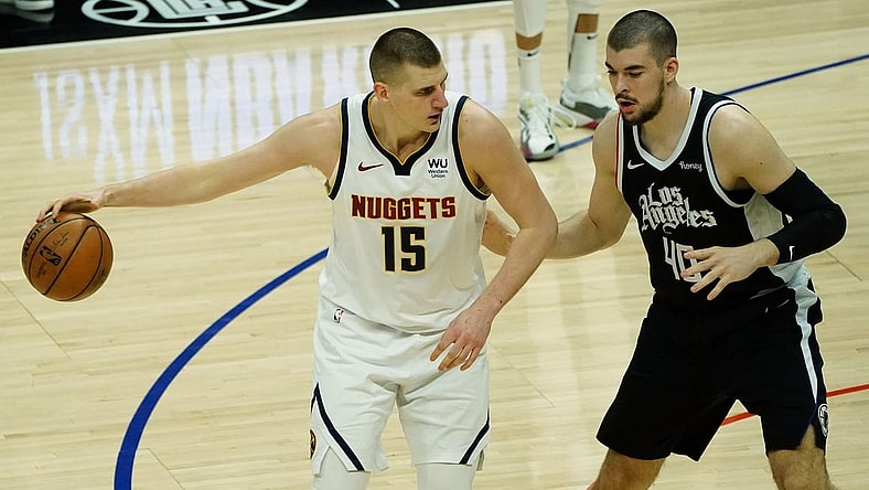 May 1, 2021; Los Angeles, California, USA; Denver Nuggets center Nikola Jokic (15) moves the ball against Los Angeles Clippers center Ivica Zubac (40) during the first half at Staples Center. Mandatory Credit: Gary A. Vasquez-USA TODAY Sports