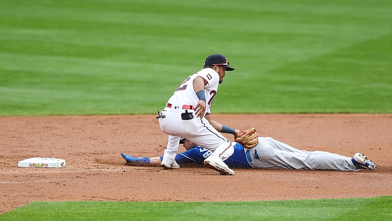 May 2, 2021; Minneapolis, Minnesota, USA; Minnesota Twins second baseman Luis Arraez (2) tags out Kansas City Royals left fielder Andrew Benintendi (16) on a steal attempt in the second inning at Target Field. Mandatory Credit: David Berding-USA TODAY Sports