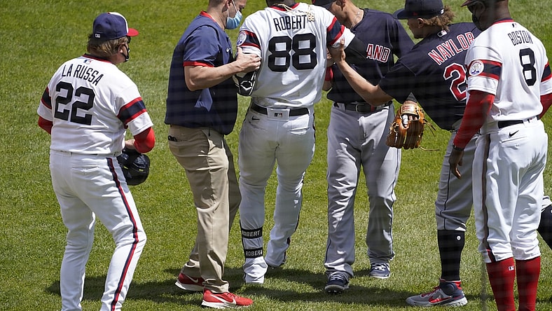 May 2, 2021; Chicago, Illinois, USA; Chicago White Sox center fielder Luis Robert (88) is helped up following an injury after beating out an infield single and had to leave the game against the Cleveland Indians during the first inning at Guaranteed Rate Field. Mandatory Credit: David Banks-USA TODAY Sports