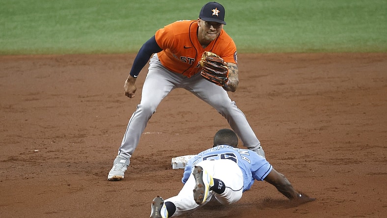 May 2, 2021; St. Petersburg, Florida, USA; Tampa Bay Rays left fielder Randy Arozarena (56) slides safely into second base as he steals and Houston Astros shortstop Carlos Correa (1) attempted to tag him out during the third inning  at Tropicana Field. Mandatory Credit: Kim Klement-USA TODAY Sports