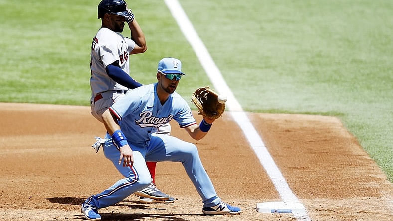 May 2, 2021; Arlington, Texas, USA; Boston Red Sox shortstop Xander Bogaerts (2) is safe at first as Texas Rangers first baseman Nate Lowe (30) catches the ball in the second inning at Globe Life Field. Mandatory Credit: Tim Heitman-USA TODAY Sports