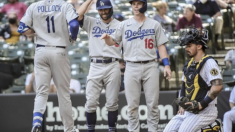 May 2, 2021; Milwaukee, Wisconsin, USA; Los Angeles Dodgers left fielder AJ Pollock (11) celebrates with left fielder Chris Taylor (3) and catcher Will Smith (16) after hitting a 3-run homer in the sixth inning as Milwaukee Brewers catcher Jacob Nottingham (26) watches at American Family Field. Mandatory Credit: Benny Sieu-USA TODAY Sports