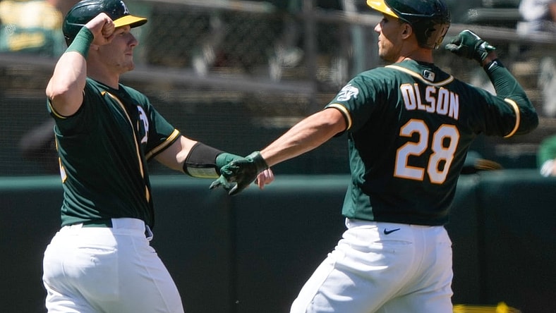 May 2, 2021; Oakland, California, USA;  Oakland Athletics catcher Sean Murphy (12) celebrates with first baseman Matt Olson (28) after scoring against the Baltimore Orioles during the third inning at RingCentral Coliseum. Mandatory Credit: Stan Szeto-USA TODAY Sports