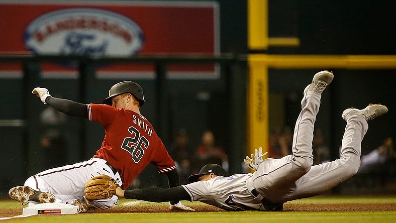 May 2, 2021; Phoenix, Arizona, USA; Rockies' Ryan McMahon (24) dives and tags out Diamondbacks' Pavin Smith (26) as he slides into third during the first inning at Chase Field. Patrick Breen-Arizona Republic

Mlb Rockies Vs Diamondbacks